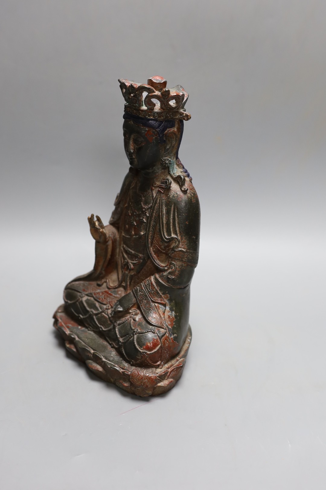 A Chinese Ming style bronze seated figure of Guanyin, 25cm